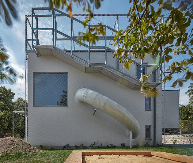 Children can slide through the tube to the ground floor.