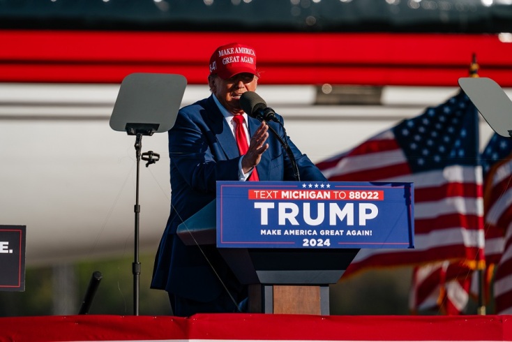 Donald Trump speaks standing on the podium